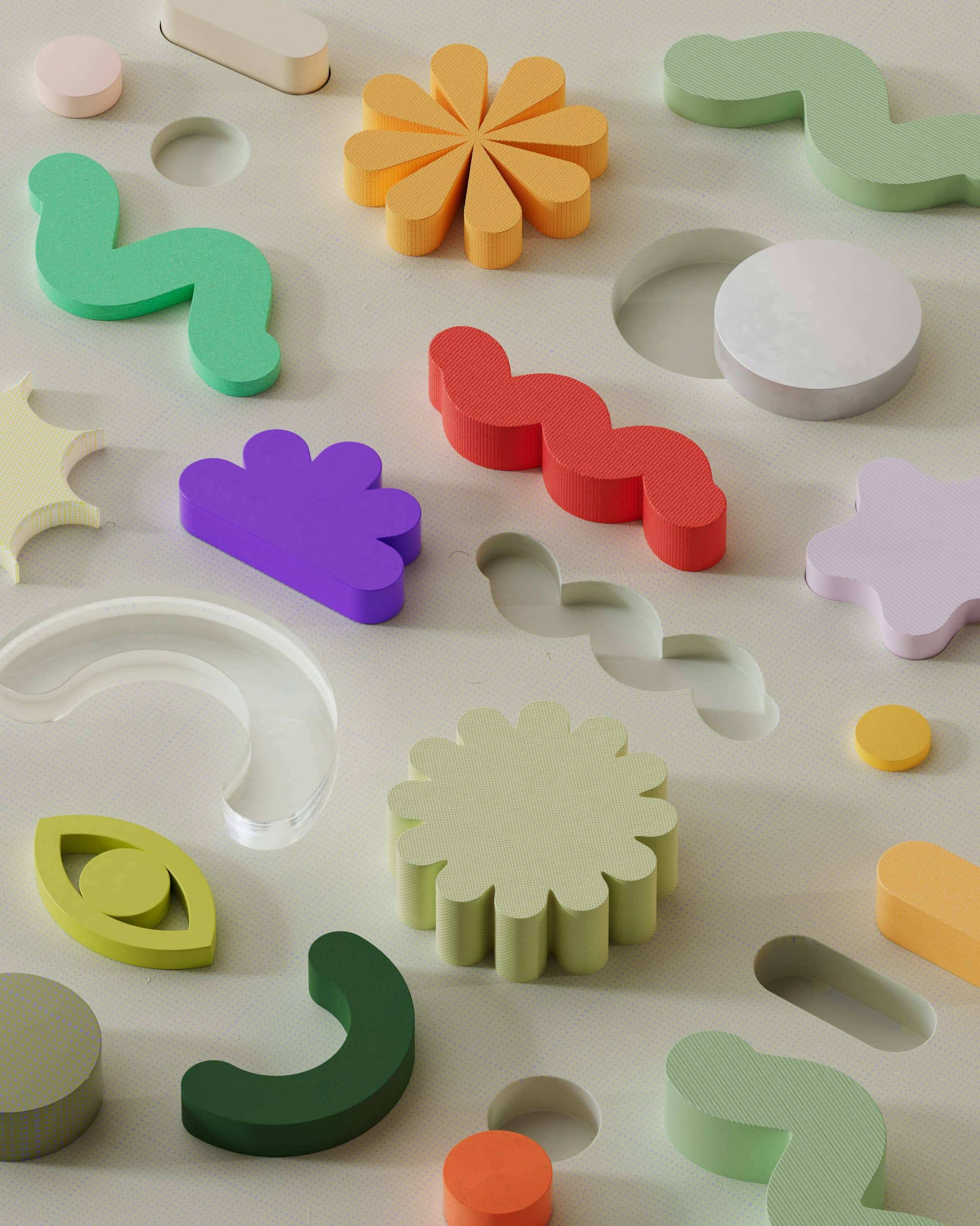 Colourful abstract shapes aligning into matching cutouts, symbolising structured content and Schema Markup in SEO.